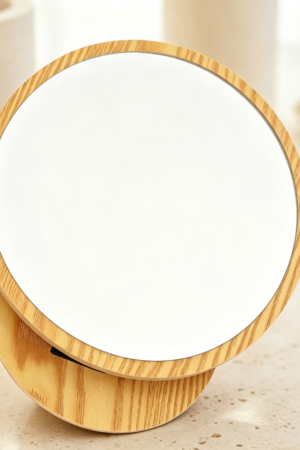 Round wooden-framed makeup mirror